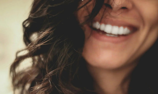 Close-up of a person smiling, representing the calm and emotional balance that comes from nervous system regulation for beginners